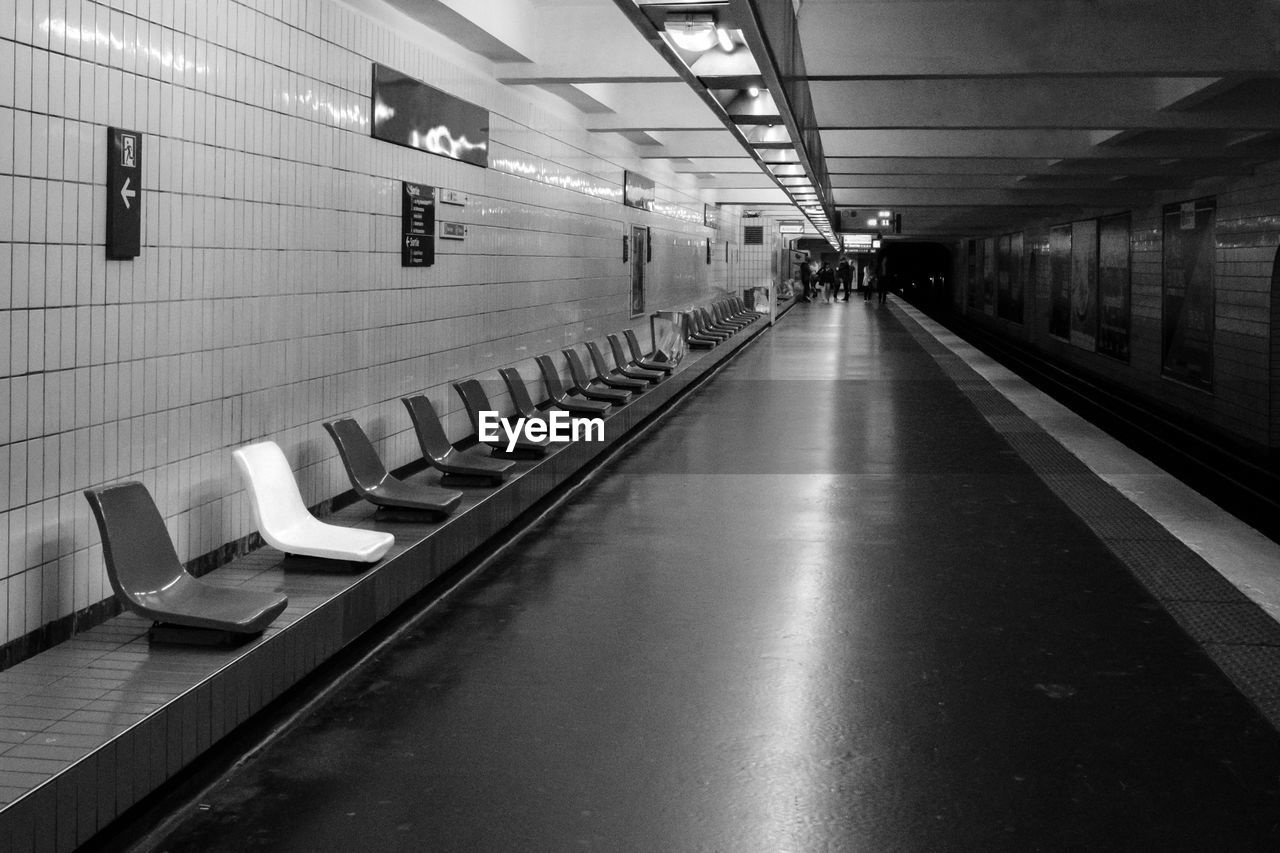 VIEW OF ILLUMINATED EMPTY UNDERGROUND WALKWAY