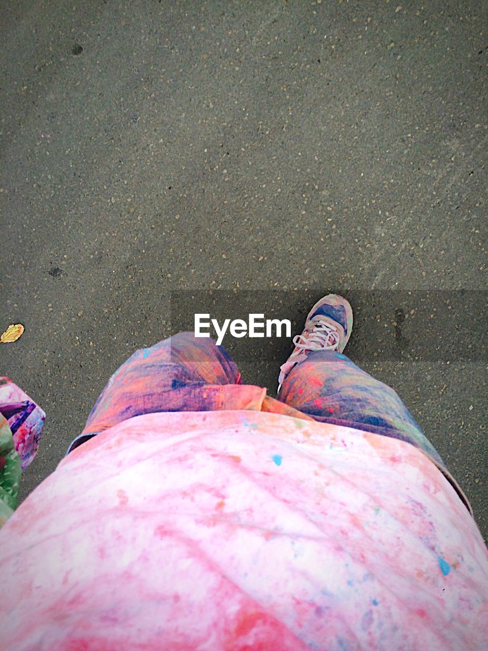 Low section of man with powder paint on clothing during holi
