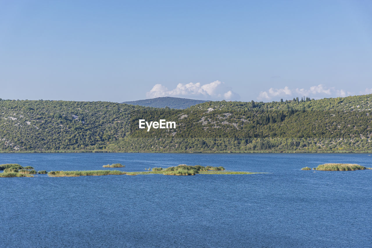 Scenic view of sea against blue sky