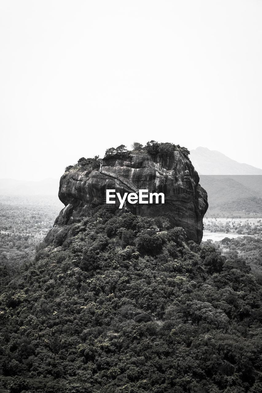 Rock formations on landscape against clear sky