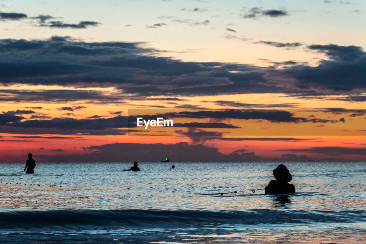 A fisherman is fishing at sunset on koh rong, cambodia