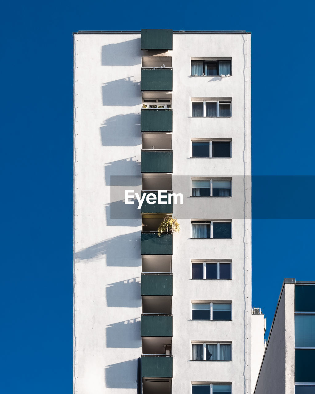 Low angle view of modern building against blue sky