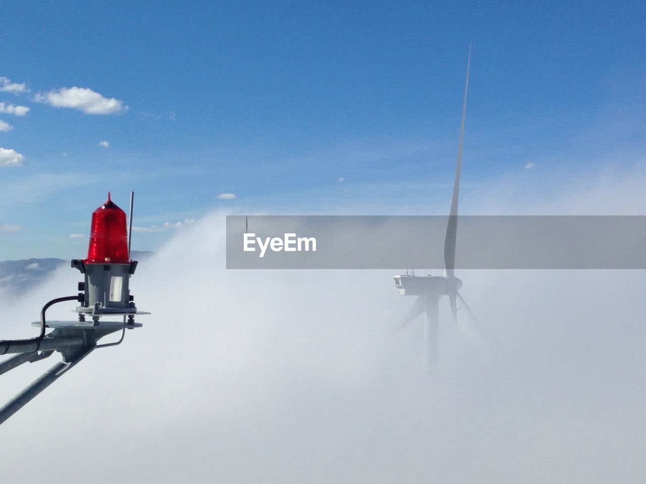 High section of windmills during foggy weather