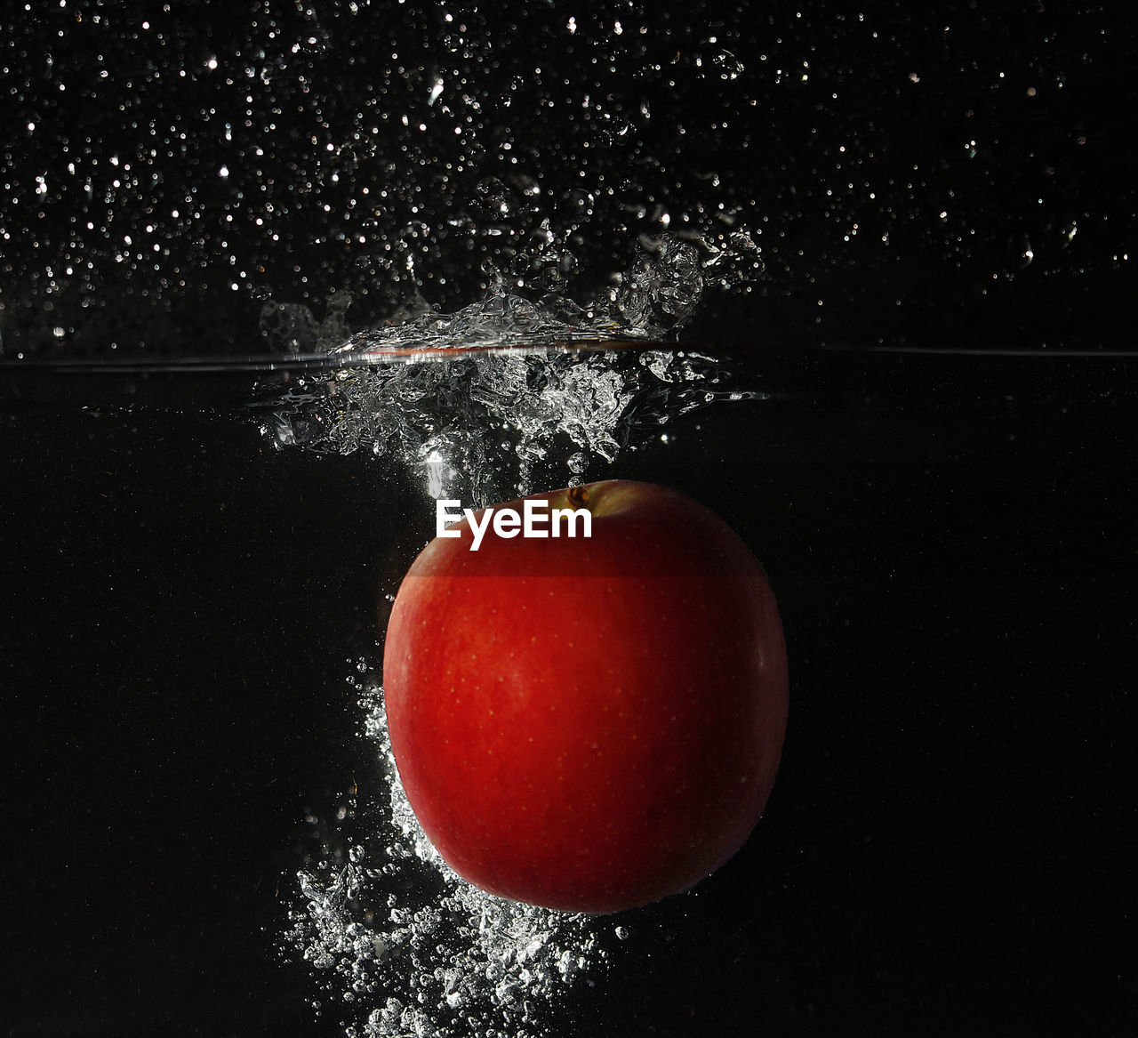 Close-up of red apple in water