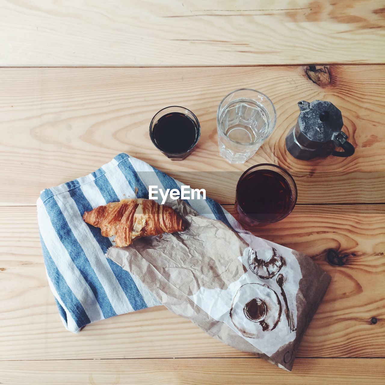 Directly above shot of coffee and croissant on table