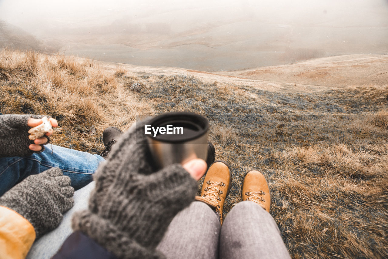 Low section of people sitting on hill during winter