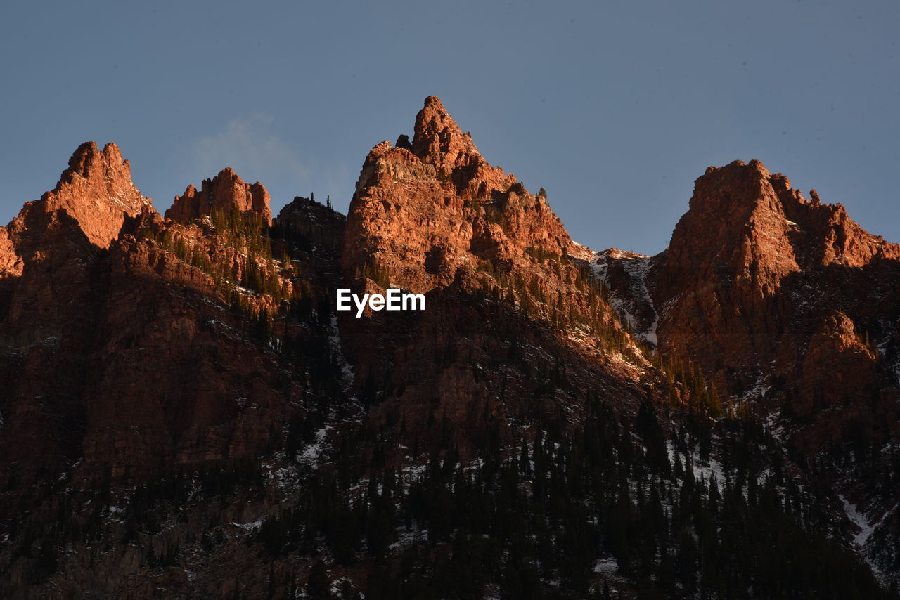 Low angle view of rocks against sky