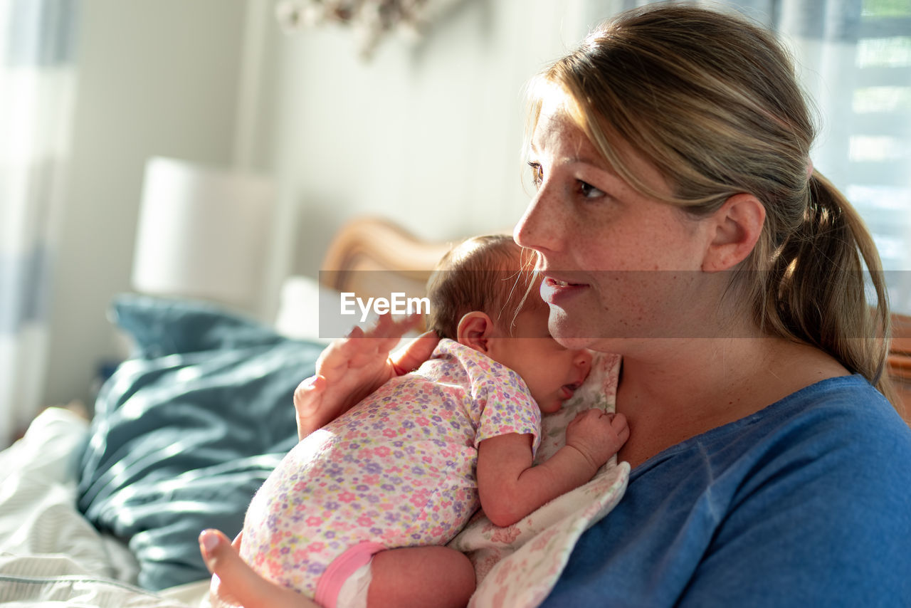 Mother and daughter on bed