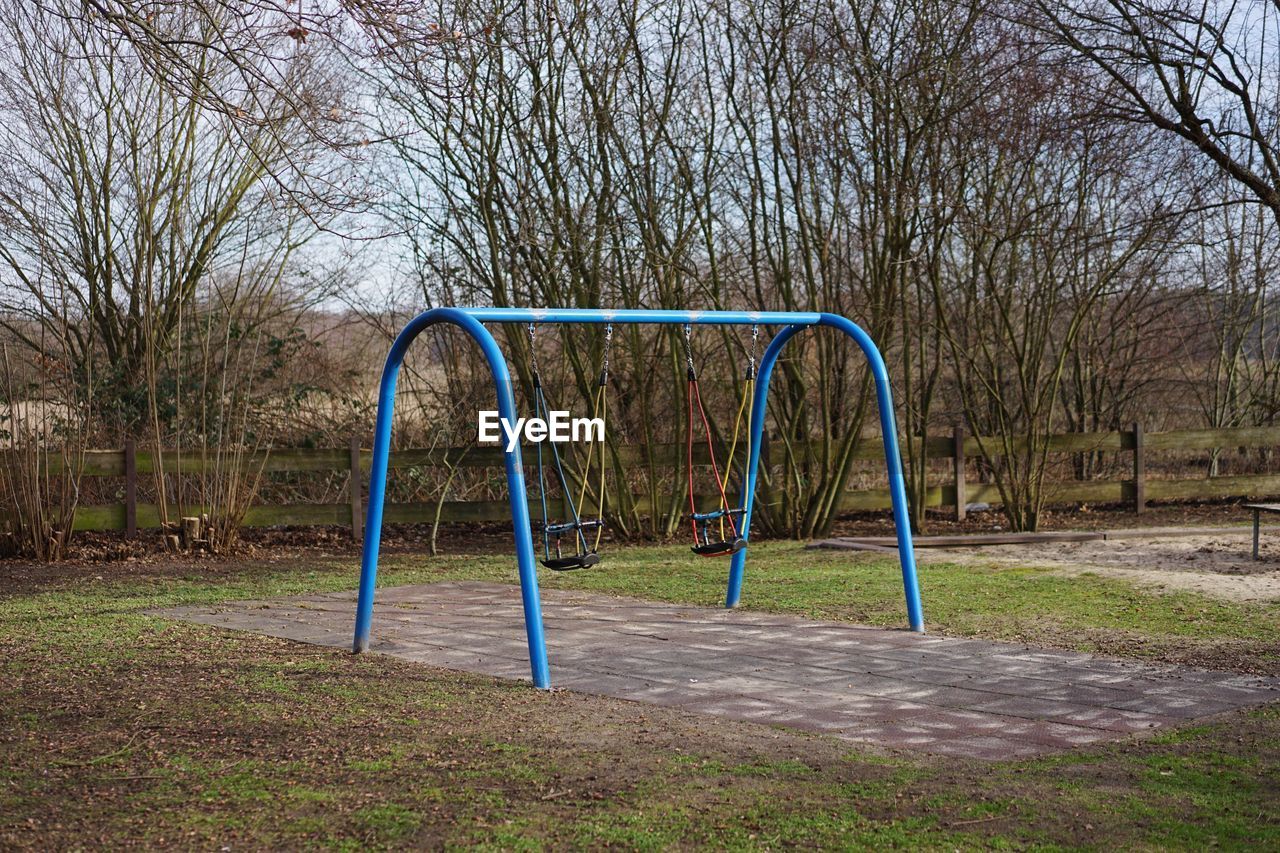 Empty swing in park during winter