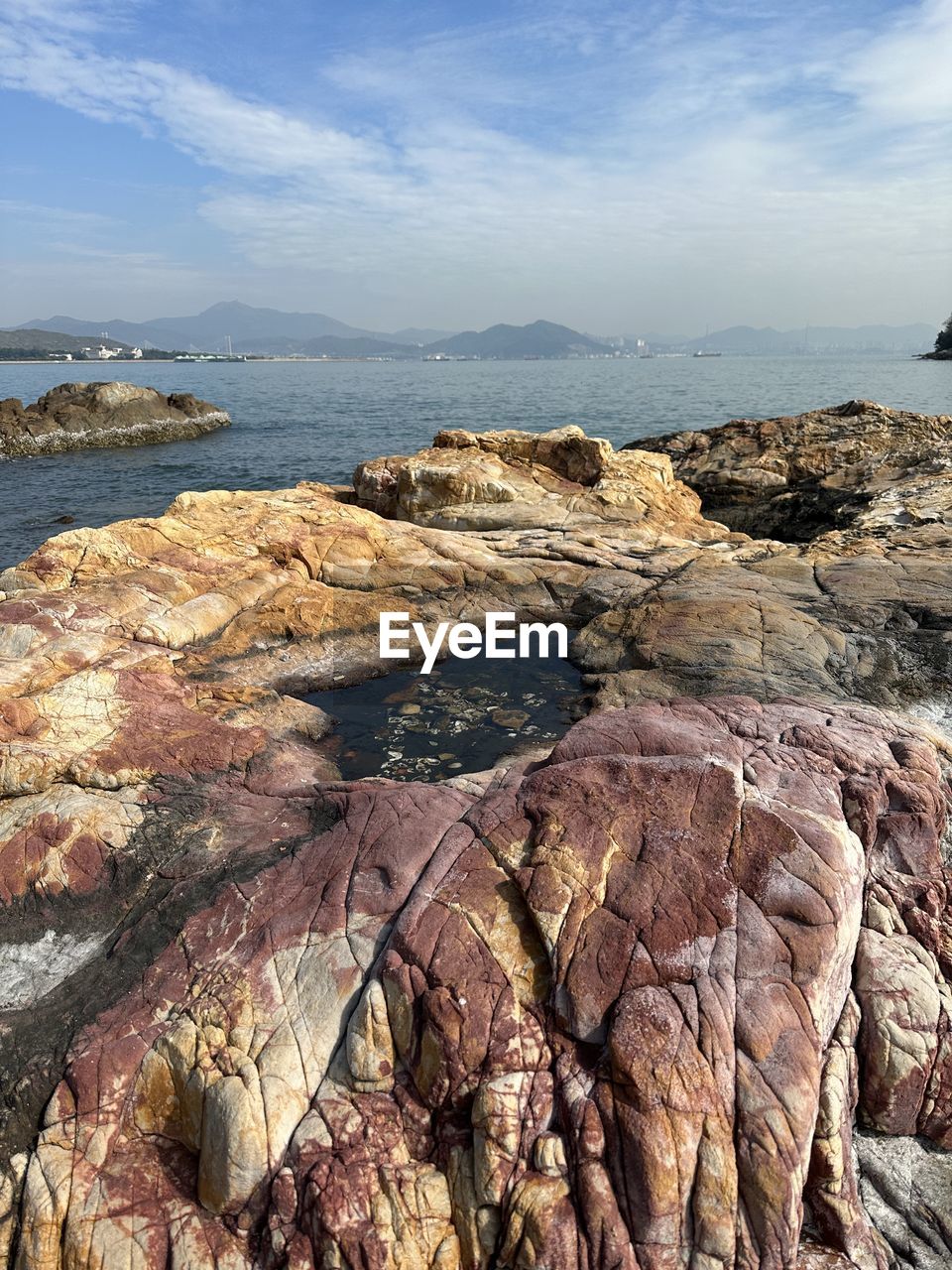 cliff, rock, water, nature, terrain, geology, beauty in nature, rock formation, day, no people, scenics - nature, sea, outdoors, land, mountain, tranquility, beach, non-urban scene, formation, high angle view, coast, cloud, sunlight, physical geography, tranquil scene, adventure, environment, canyon, sky