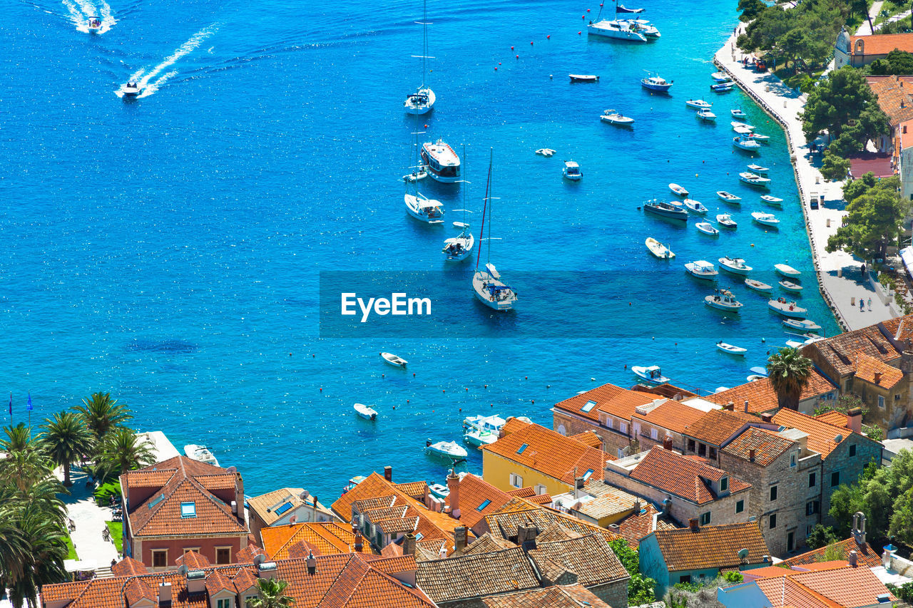 High angle view of boats in sea by town