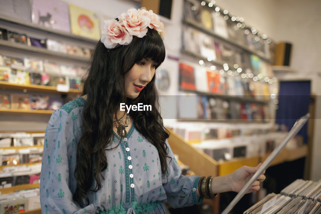 Young woman browsing albums in a record store
