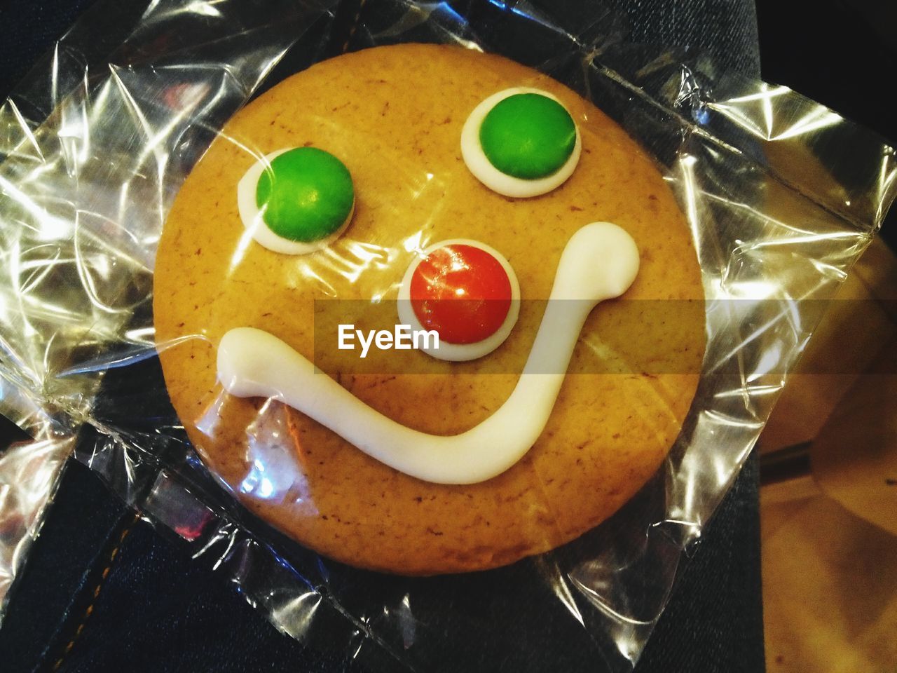 High angle view of fresh baked cookie with anthropomorphic face in plastic packet