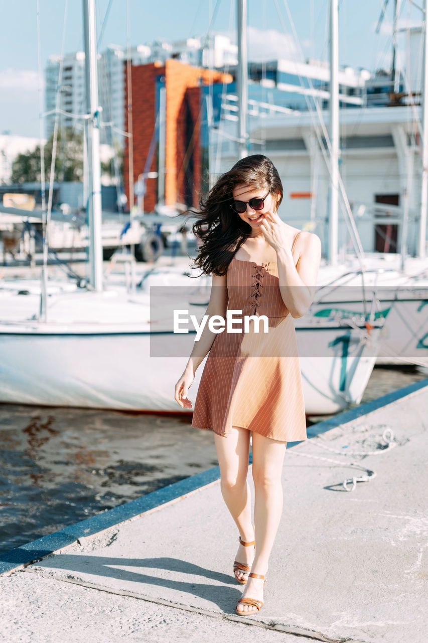 FULL LENGTH OF YOUNG WOMAN IN BOAT