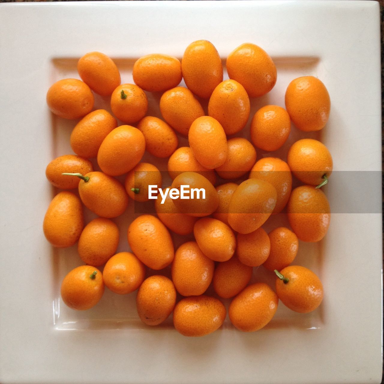 High angle view of kumquats in plate on table