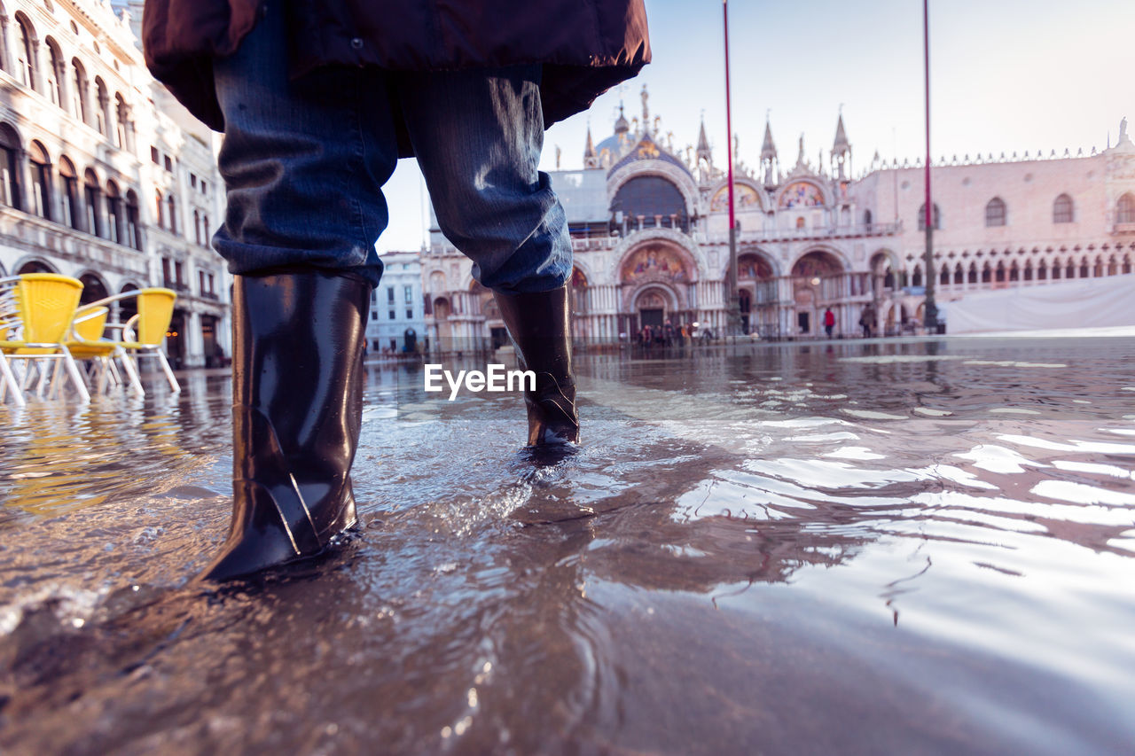 Low section of man in flooded st. mark's square