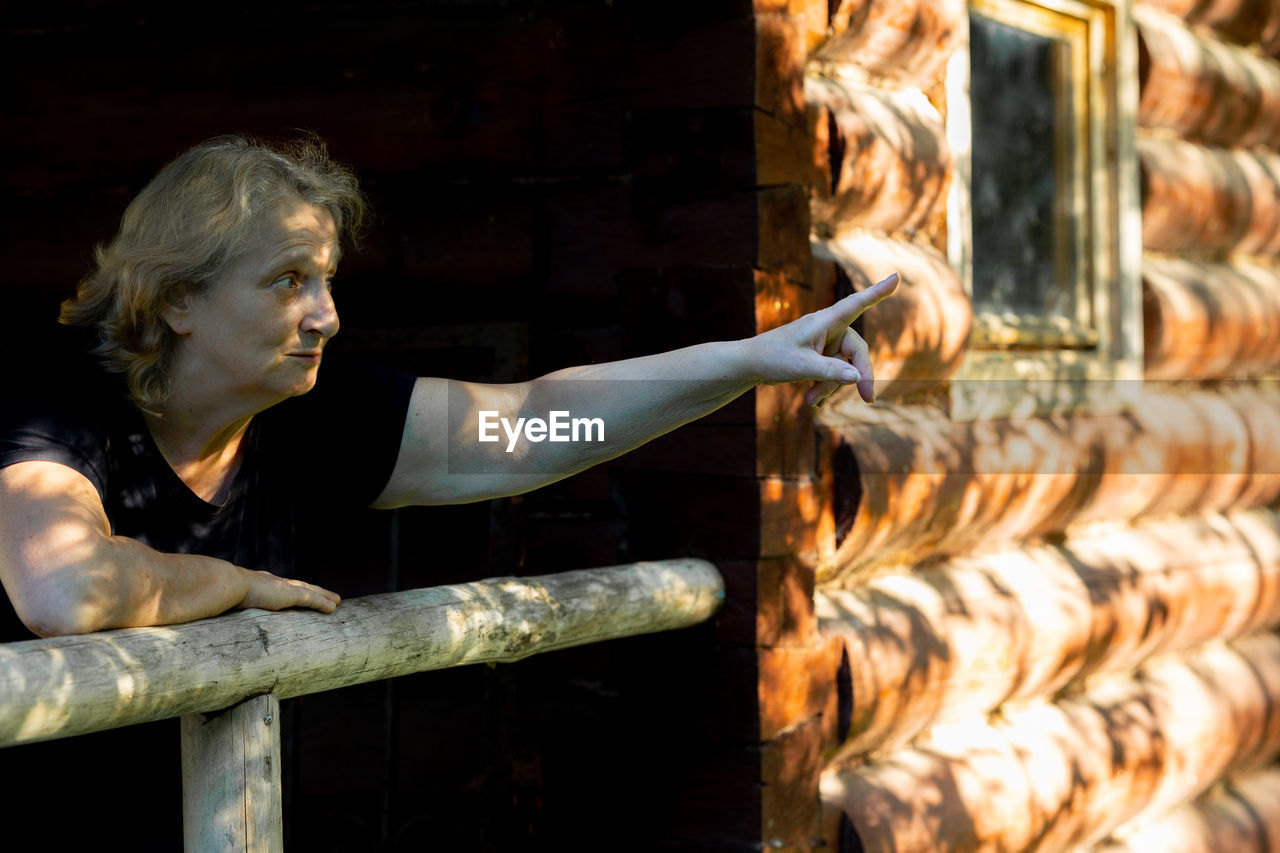 Portrait of elderly woman close-up on natural background. sunset light on face of senior