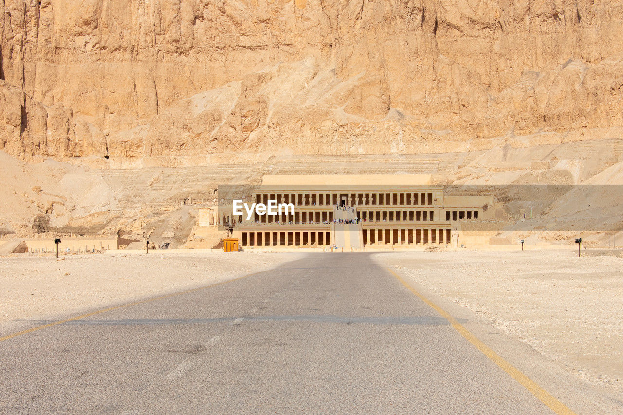 wadi, sand, desert, land, no people, architecture, nature, road, day, landscape, ancient history, built structure, transportation, travel destinations, natural environment, travel, outdoors, history, arid climate, sunlight, scenics - nature, environment, the past, climate, ancient, empty, wall, rock, the way forward