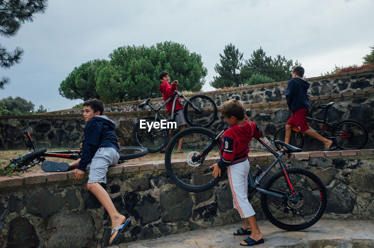 PEOPLE ON BICYCLE AGAINST MOUNTAIN