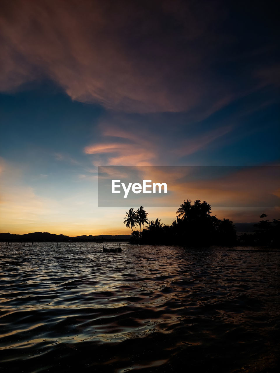 sky, water, cloud, beauty in nature, sunset, scenics - nature, sea, tranquility, nature, tranquil scene, tree, horizon, evening, reflection, land, ocean, dusk, no people, environment, tropical climate, idyllic, outdoors, silhouette, beach, plant, seascape, travel destinations, dramatic sky, palm tree, landscape, afterglow, sunlight, wave, shore, coast, travel, non-urban scene, island