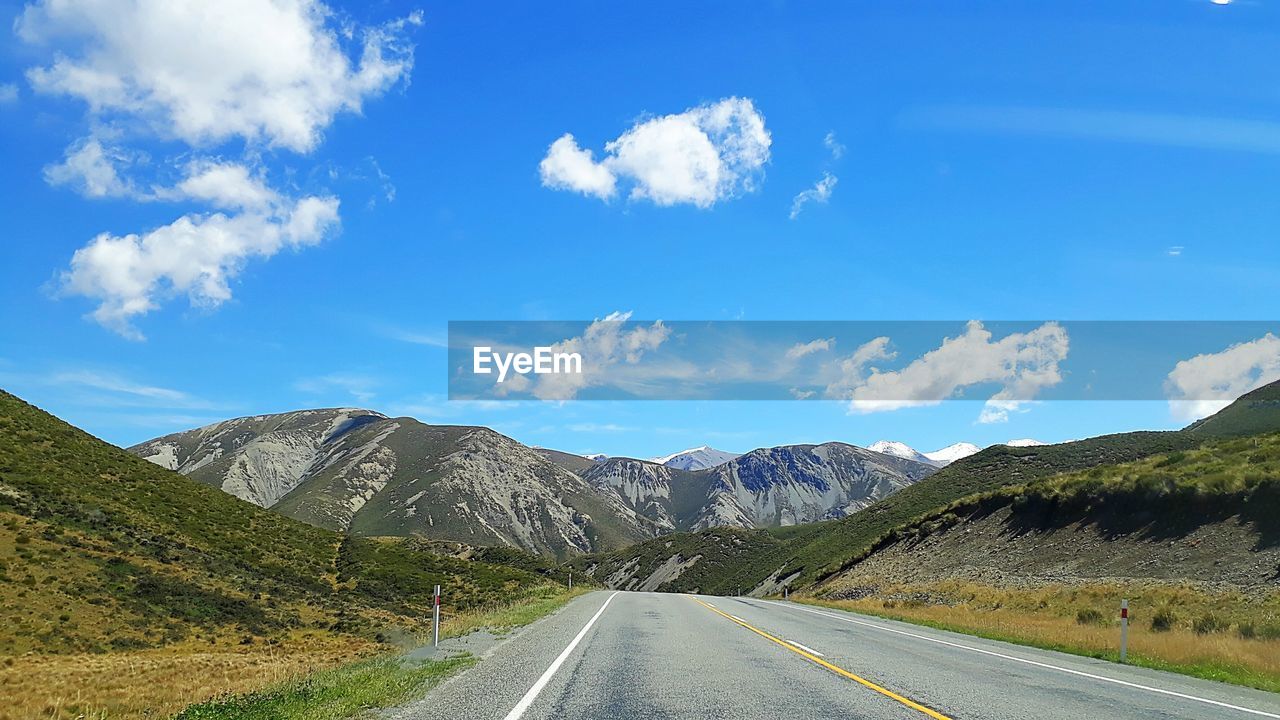 ROAD BY MOUNTAIN AGAINST SKY