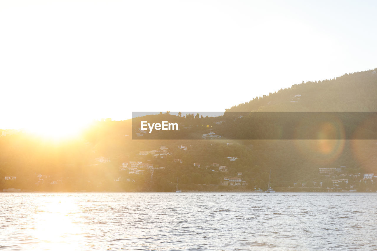 Scenic view of bright sun over water