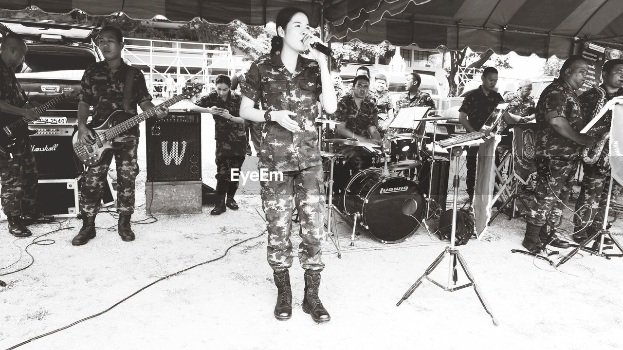 GROUP OF PEOPLE STANDING ON STAGE