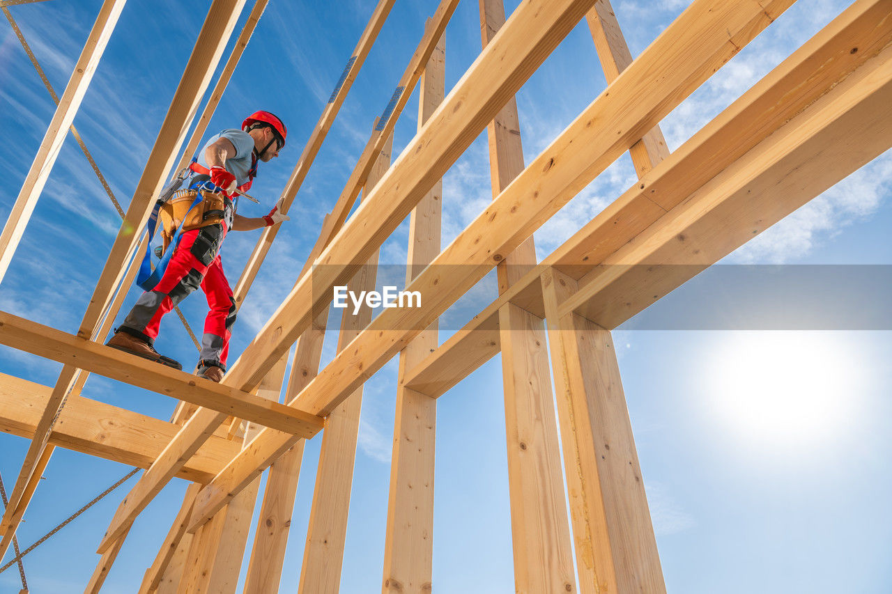 low angle view of man walking on wall