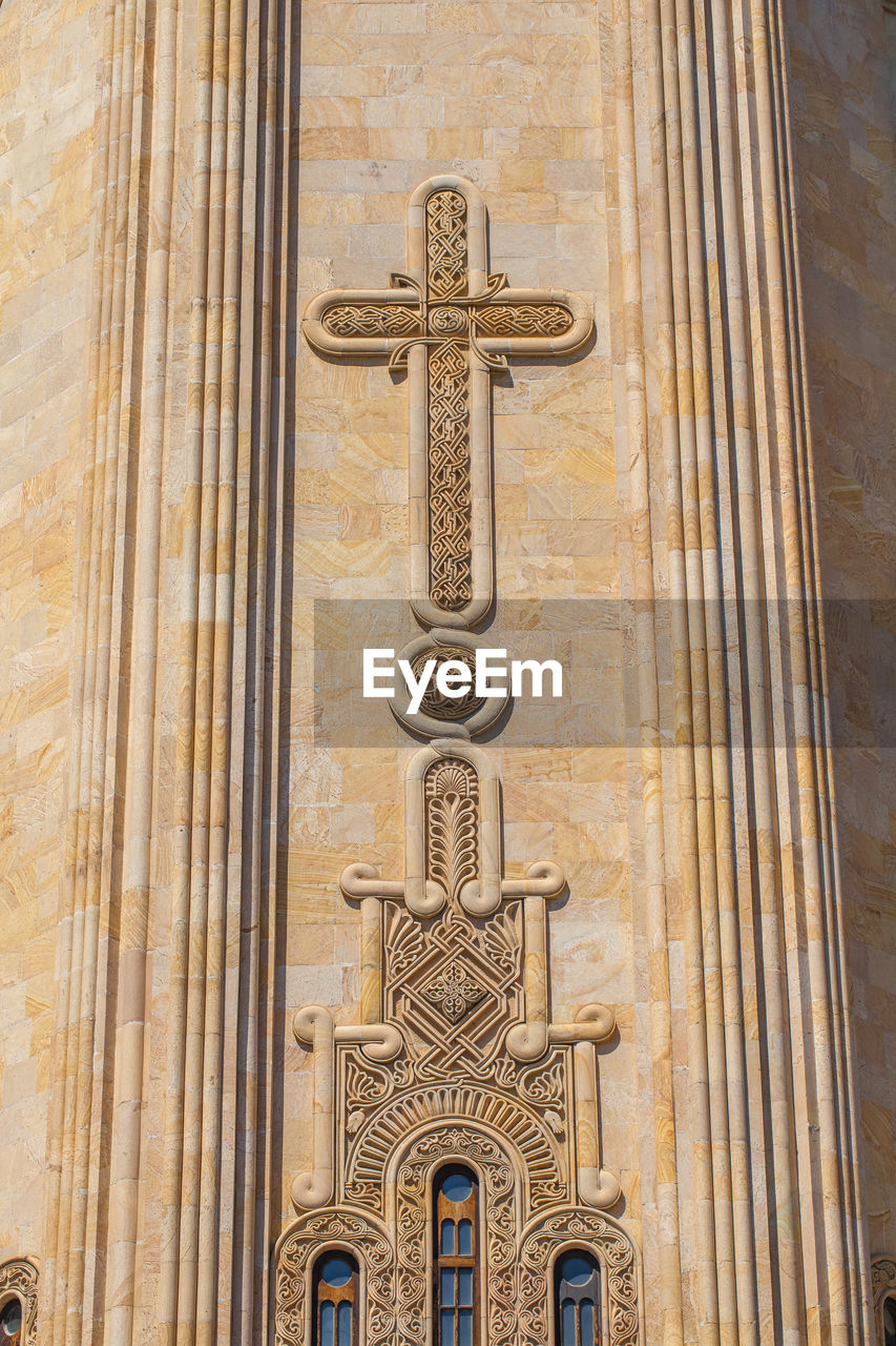 Low angle view of cross pattern on church wall