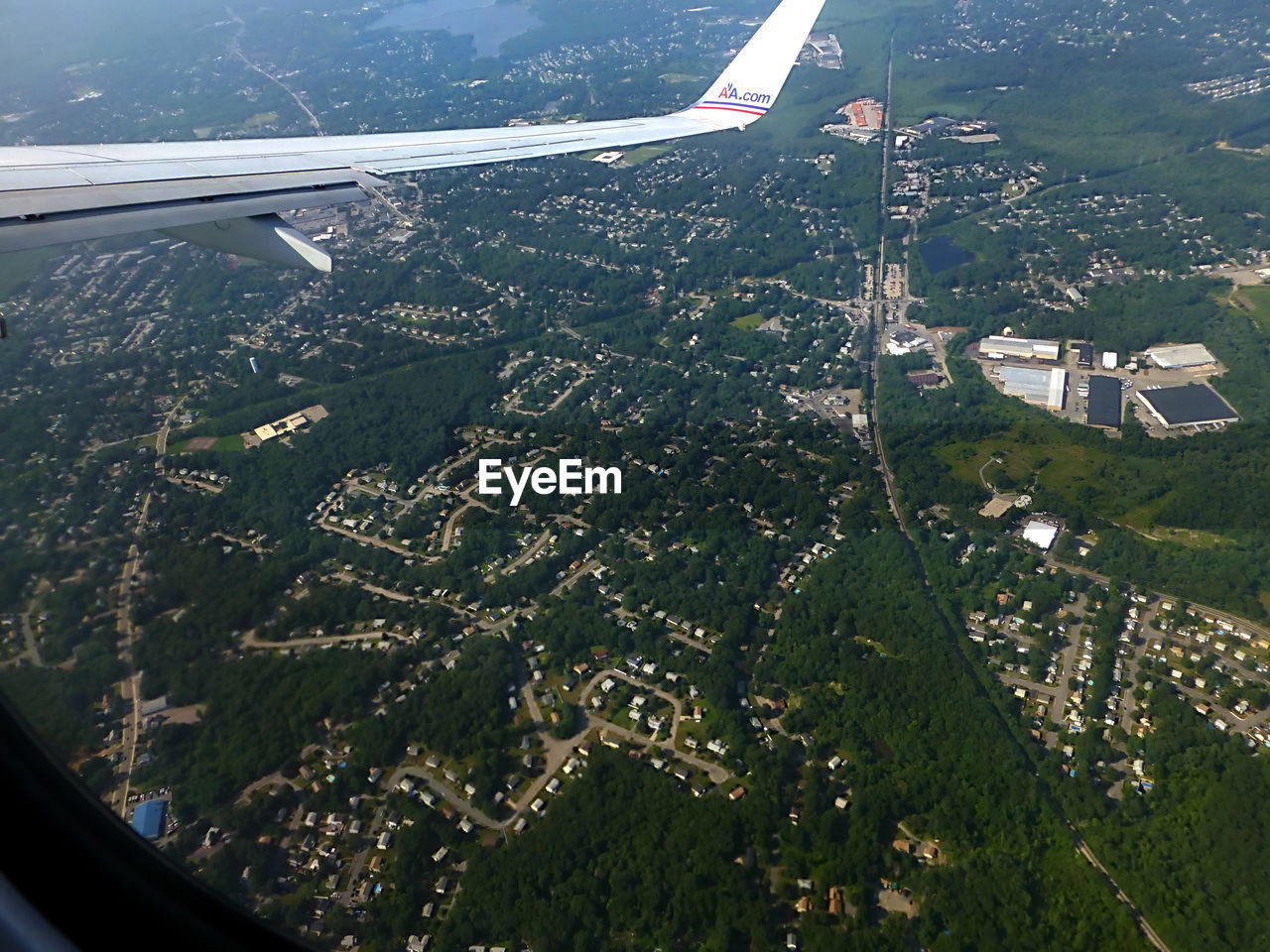 CROPPED IMAGE OF AIRPLANE WING OVER SEA