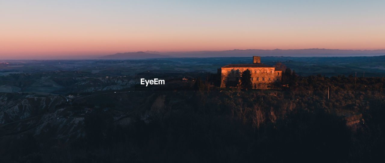 PANORAMIC VIEW OF OLD BUILDING AT SUNSET