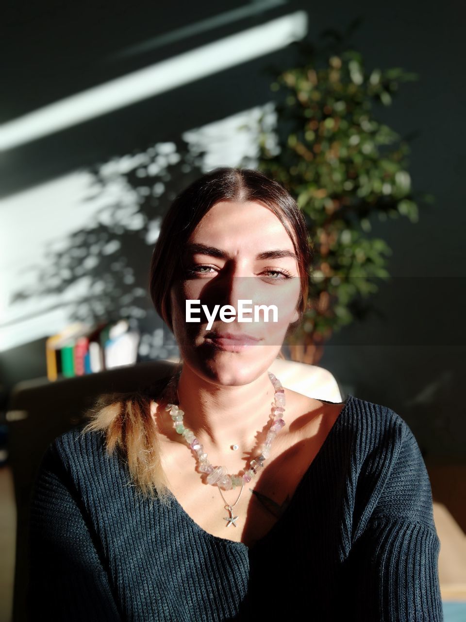 High angle view of sunlight falling on woman sitting at home