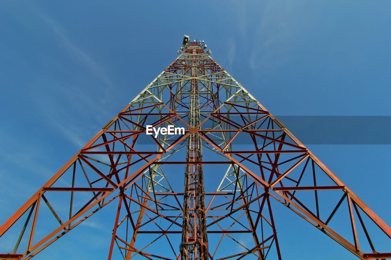 Low angle view of communication tower with blue sky