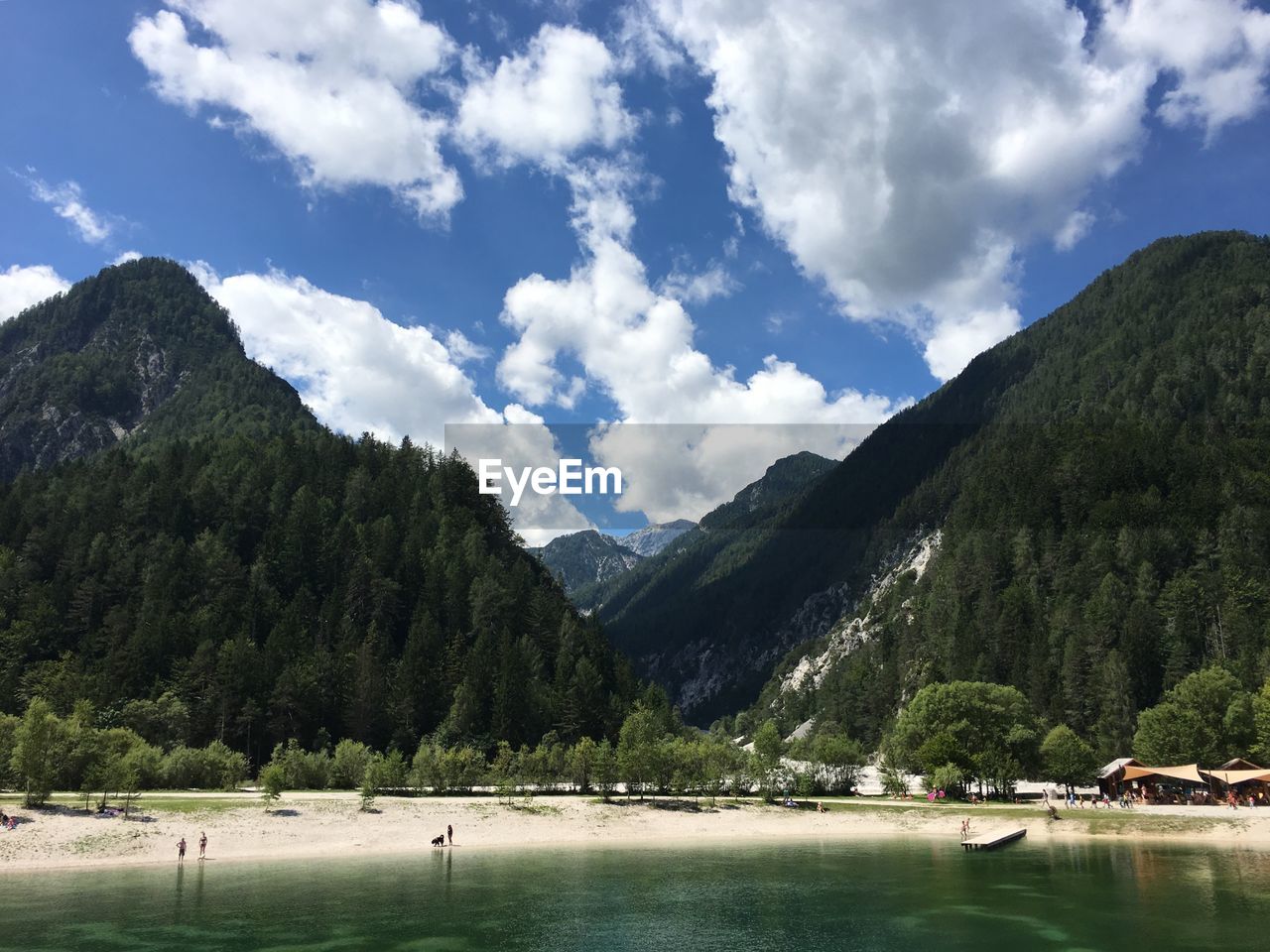 Scenic view of mountains by lake against sky