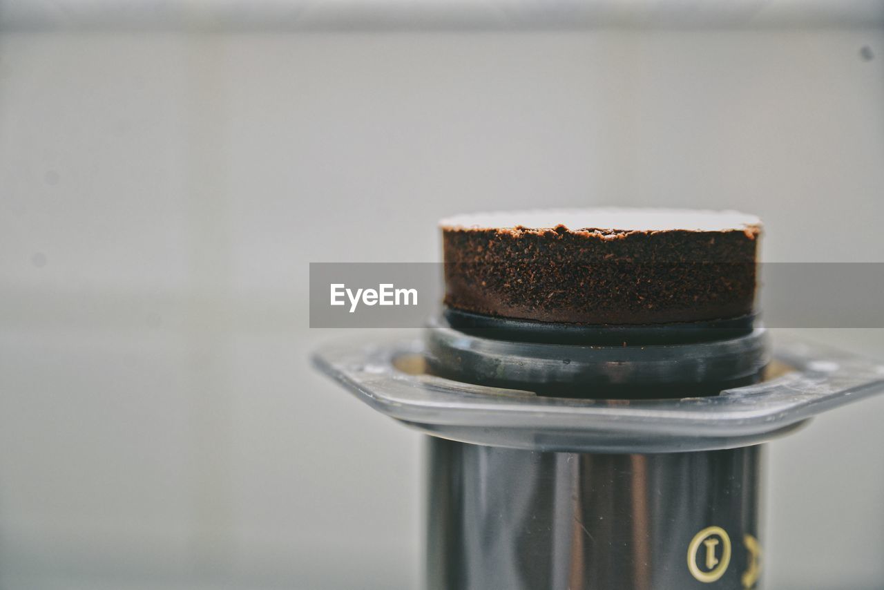 Close-up of aeropress coffee on table