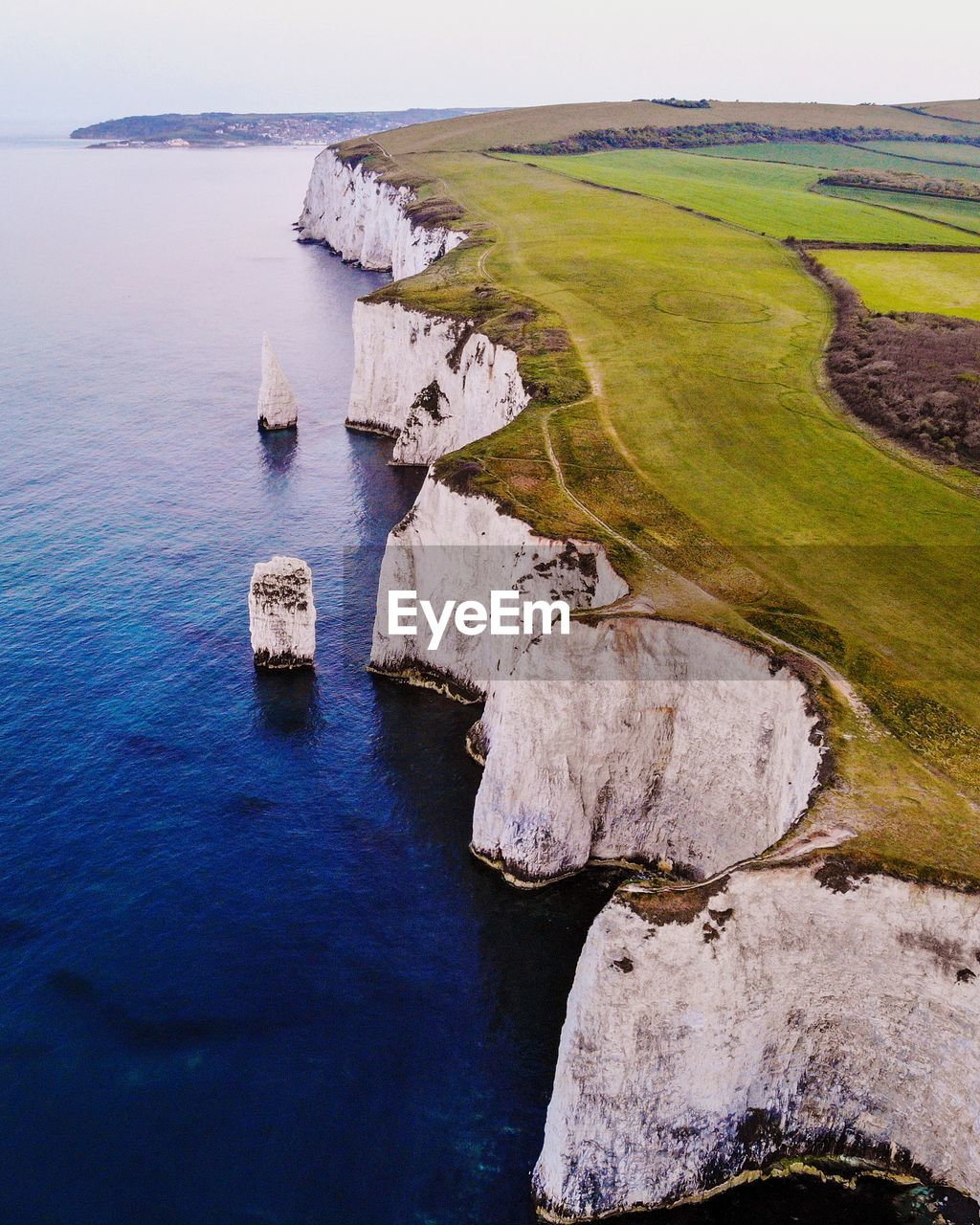 Aerial view of cliff by sea against sky