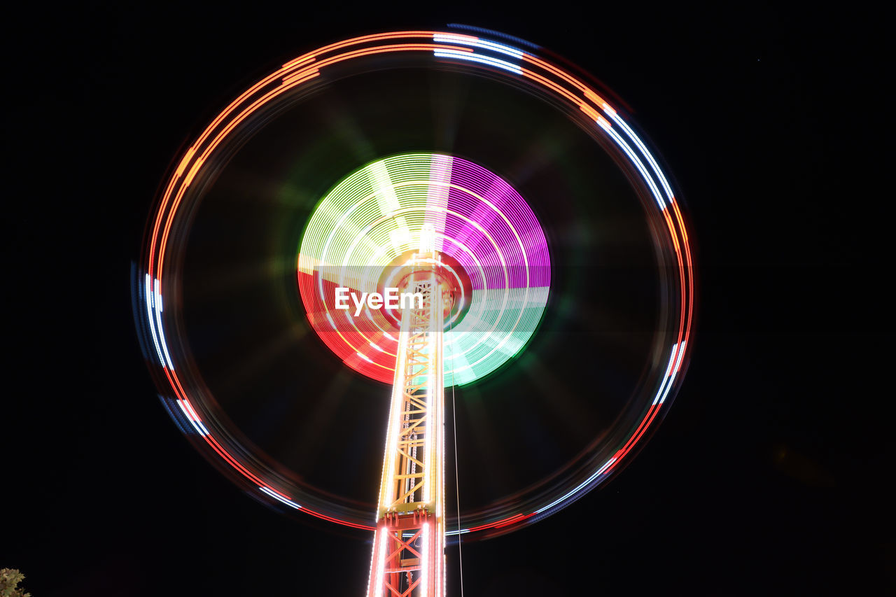 Low angle view of illuminated ferris wheel at night