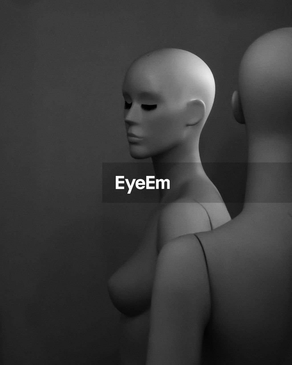 Close-up of mannequins against dark background