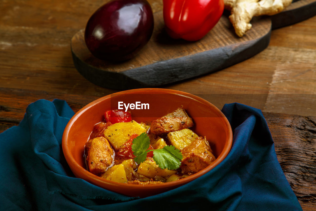 Food for suhoor in ramadan lamb stew with potatoes vegetables on a blue napkin. horizontal photo