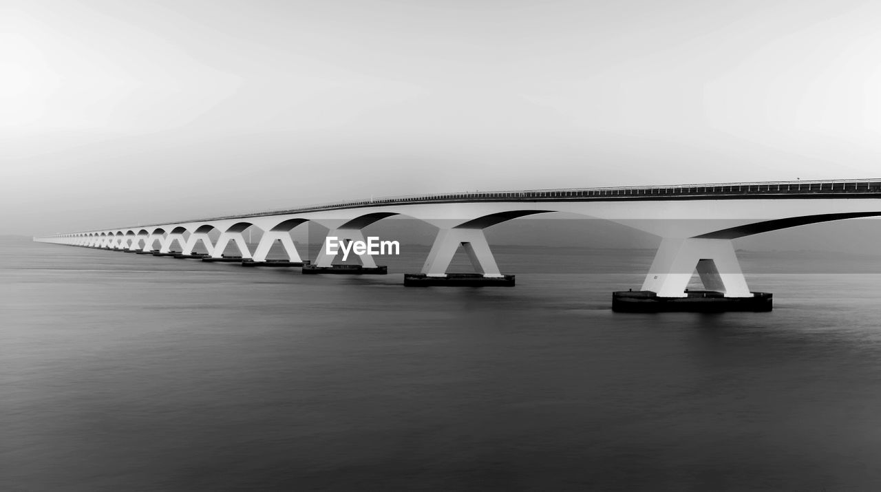 Zeeland bridge over bay against clear sky