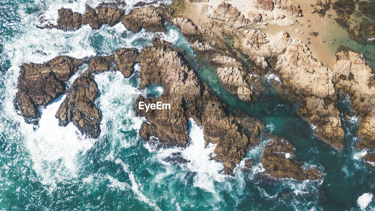 High angle view of rock formations in sea