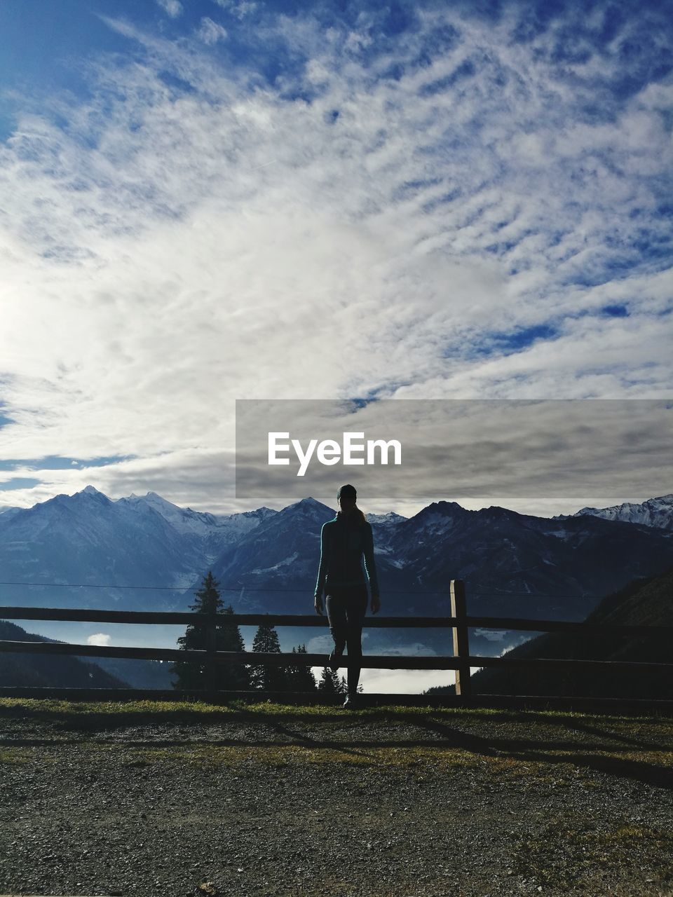 FULL LENGTH REAR VIEW OF MAN STANDING ON SNOWCAPPED MOUNTAIN AGAINST SKY