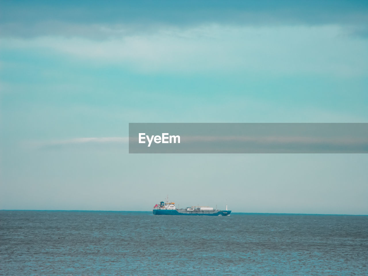 Boat sailing in sea against sky