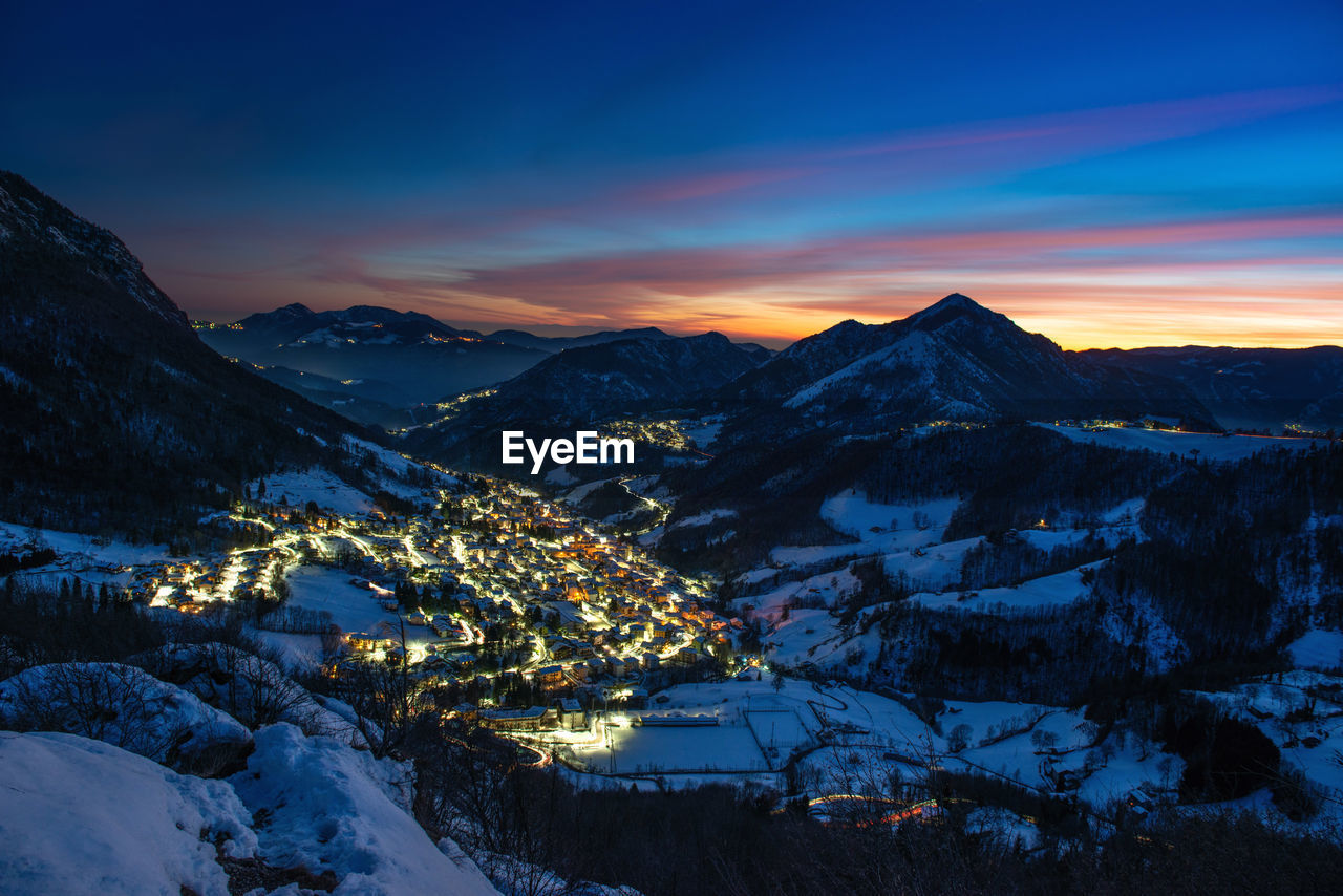Snowy ski resort at sunset