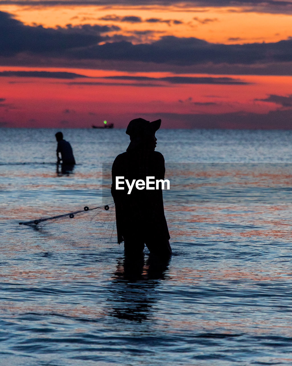 A fisherman is fishing at sunset on koh rong, cambodia