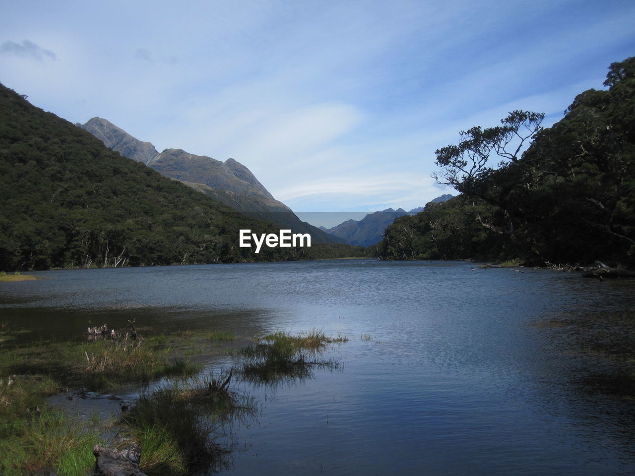 Scenic view of lake and mountains against sky