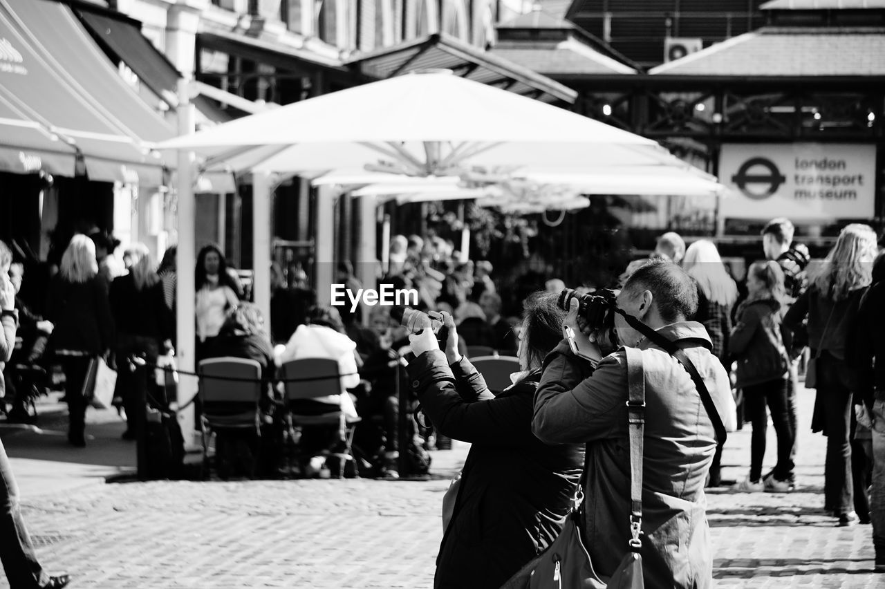 GROUP OF PEOPLE WALKING IN CITY