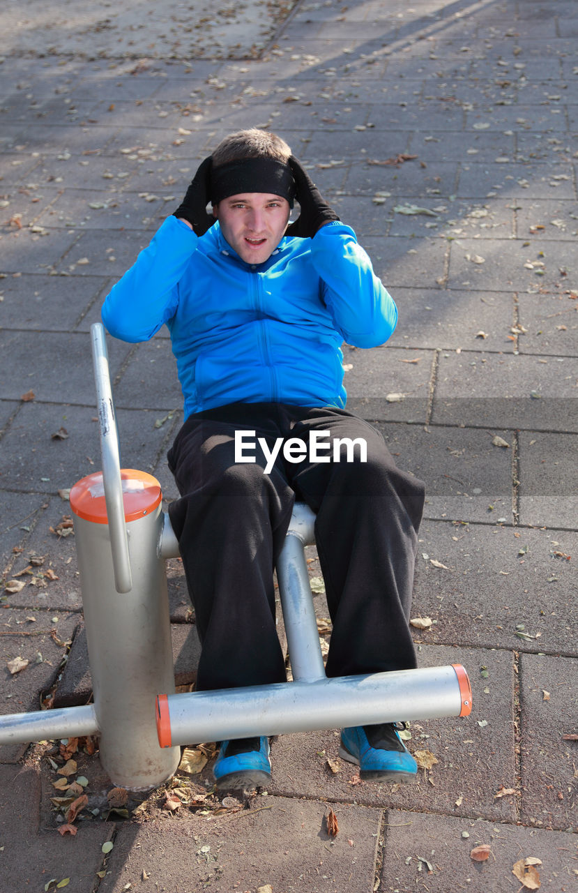 Full length of man exercising at public park