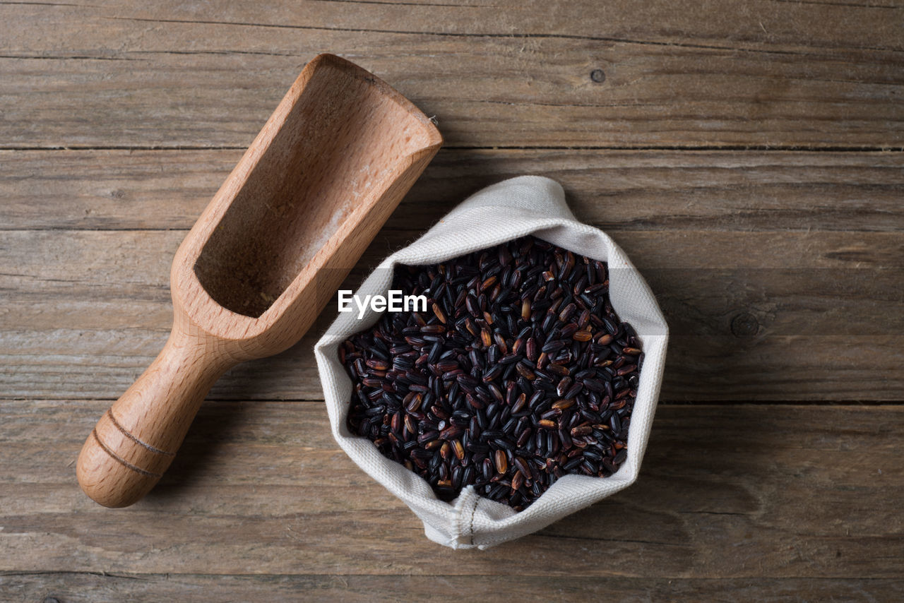 Directly above shot of beans with wooden spoon on table