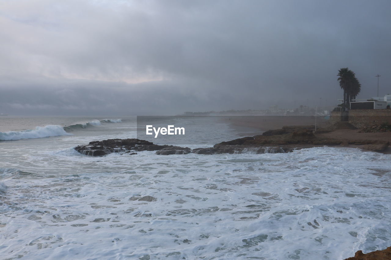 SCENIC VIEW OF SEA SHORE AGAINST SKY